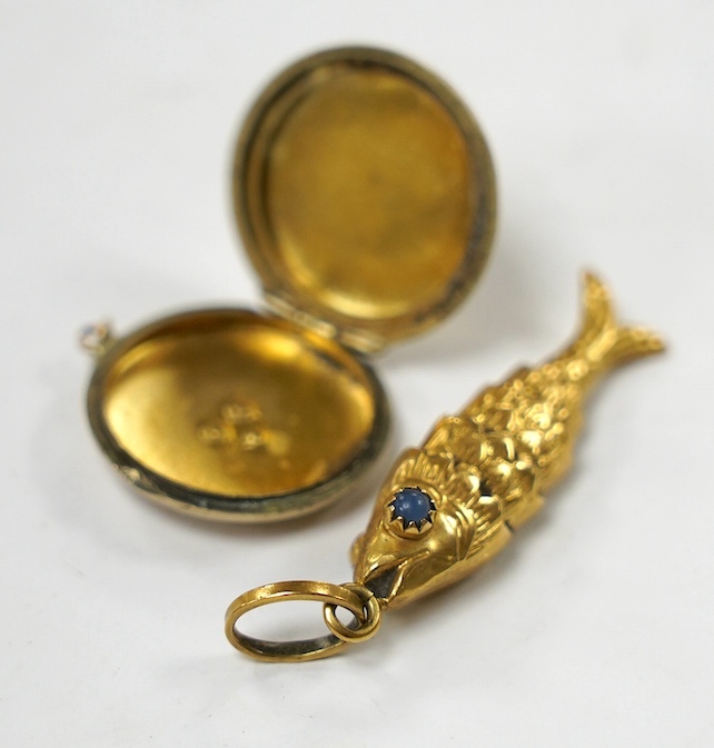 An Italian 750 yellow metal and two stone blue cabochon set articulated gold fish pendant, overall 46mm and a yellow metal and split pearl set circular locket. Condition - poor to fair